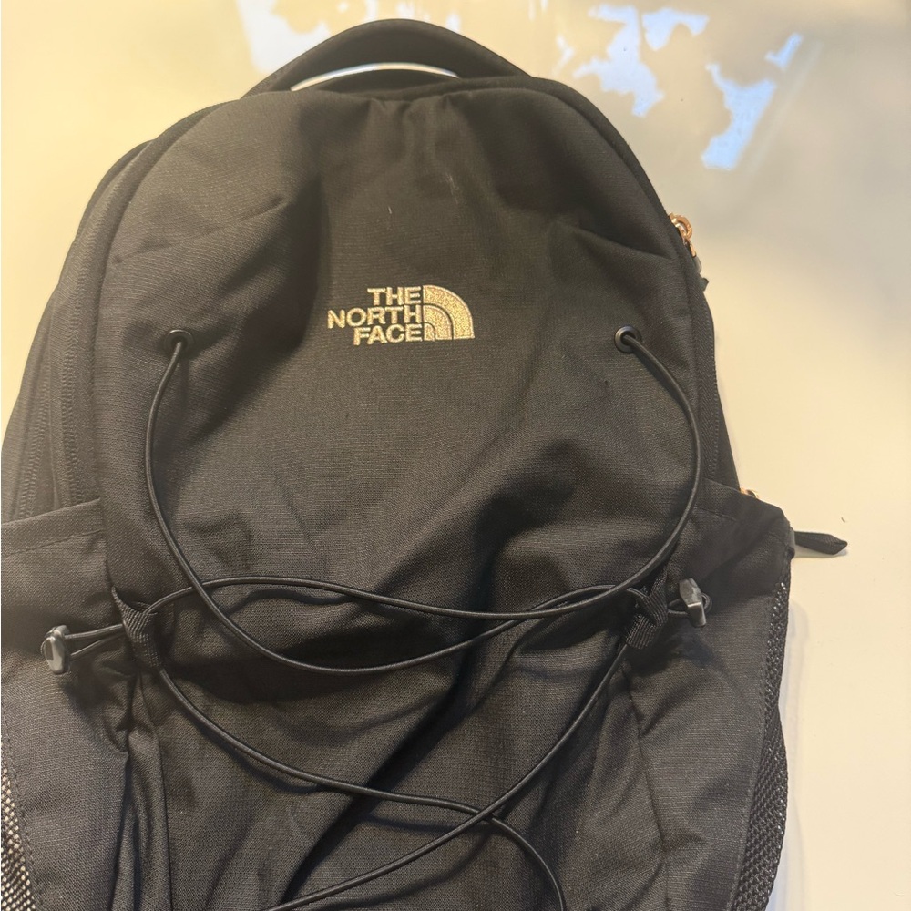 The North Face Black Backpack with Gold Logo